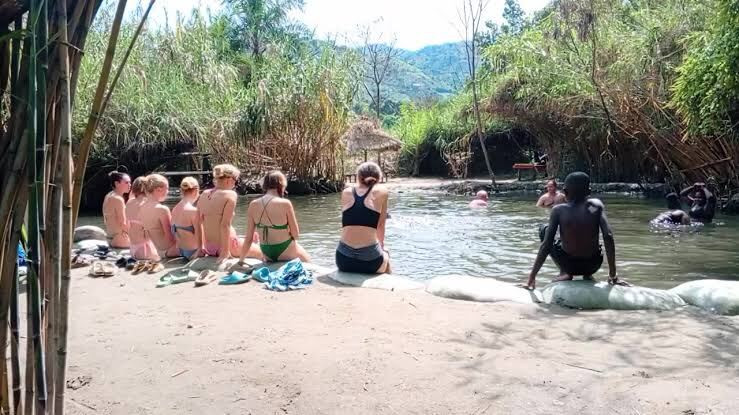 Guests relaxing in the river at the hot springs