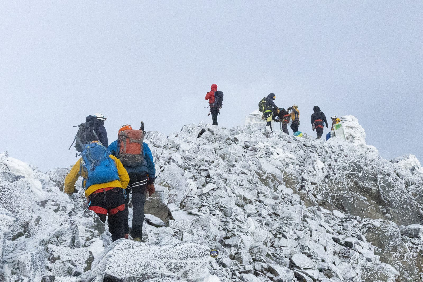 Climbers near the Margherita Peak summit sign
