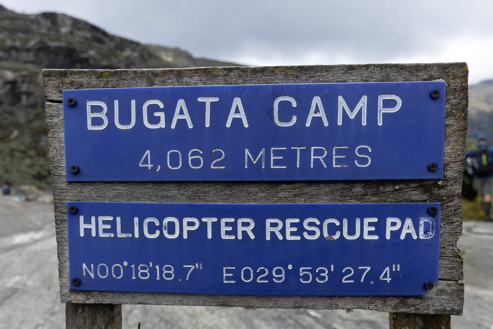 Bugata Camp sign at 4,062 metres with helicopter rescue pad